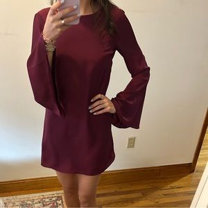 Likely mini dress with long bell sleeves - deep purple/pink color